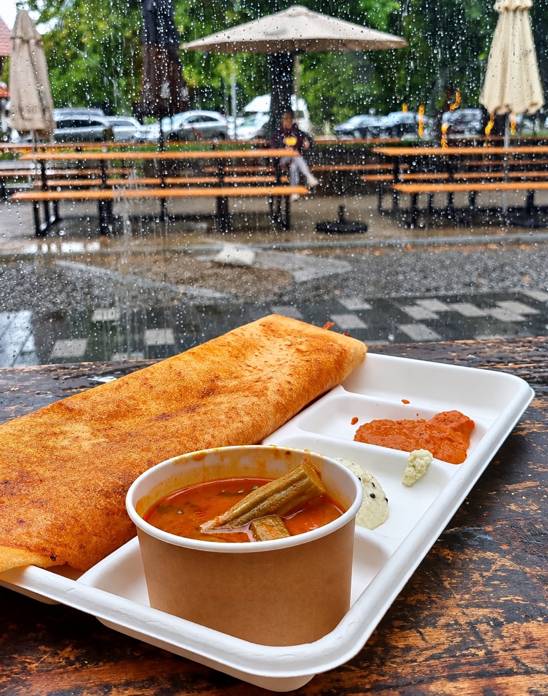 Masala dosa with sambar, coconut chutney and tomato chutney on a table at Riverside Market